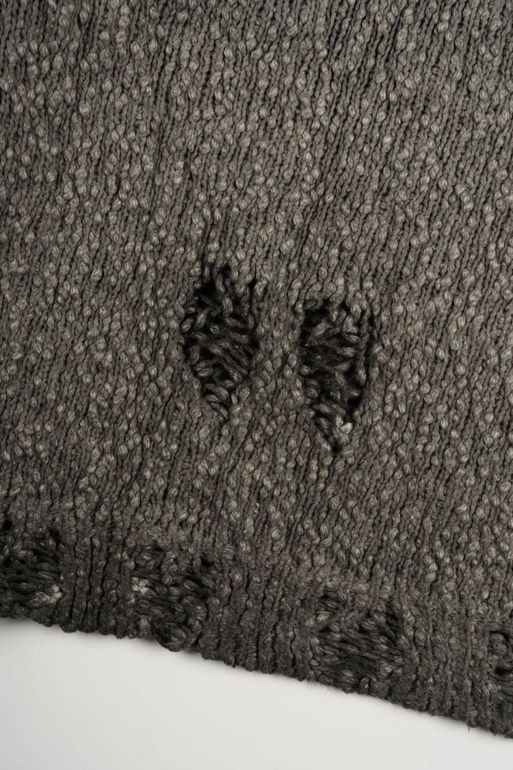 ARTEMIS distressed reversible knit sweater, close-up of the distressed knit hem