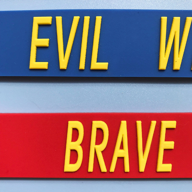 EOH-STUDIO BTBM blue EVIL and red BRAVE raised-letter silicone, close-up detail.