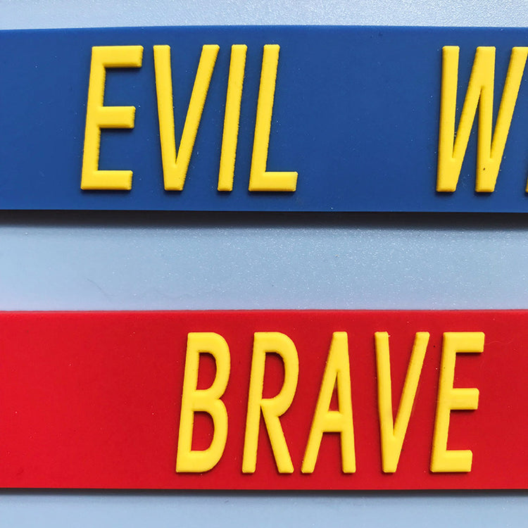 EOH-STUDIO BTBM blue EVIL and red BRAVE raised-letter silicone, close-up detail.