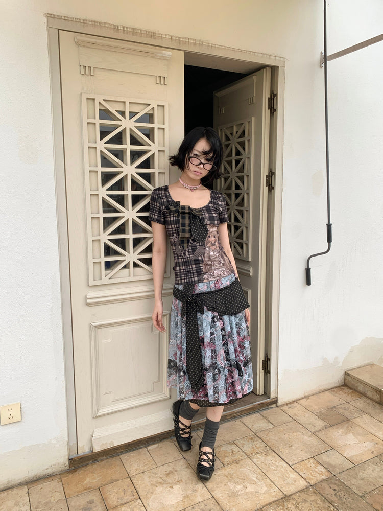 4RE1GN CROSS RIBBON jacquard lace layered skirt in multicolor — full-length modeled view in an exterior doorway