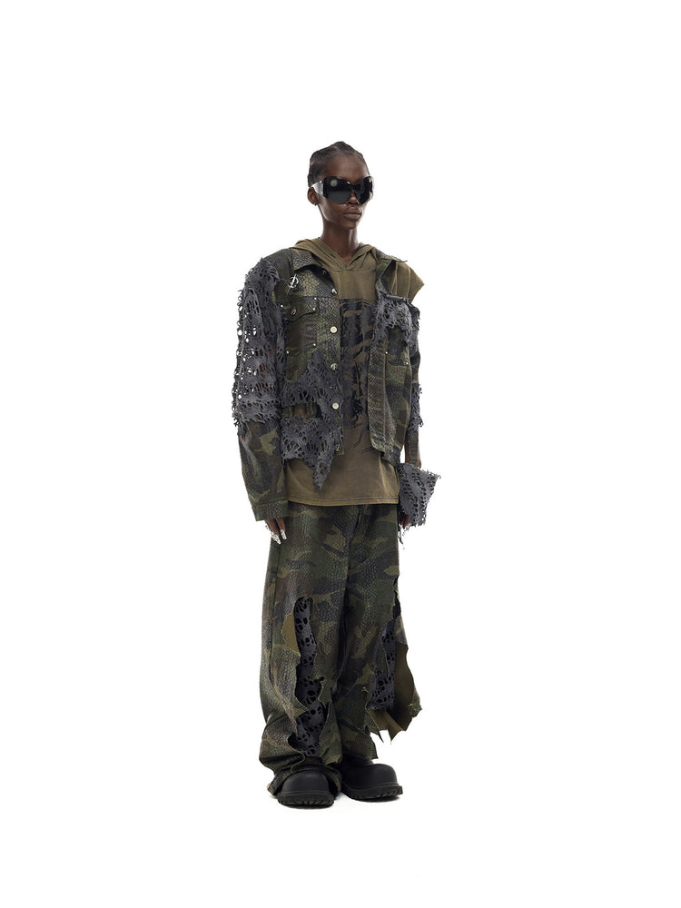 PINKSPINK ELECTRIC MOON distressed camouflage denim jacket — angled full-length modeled view layered over an olive top