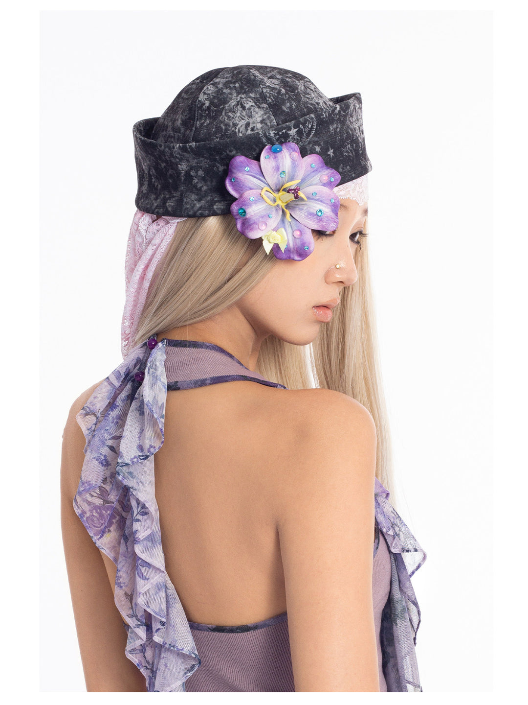 4RE1GN MYSTIC printed brimless hat — black-gray mystic print — side modeled close-up with a flower styling accessory