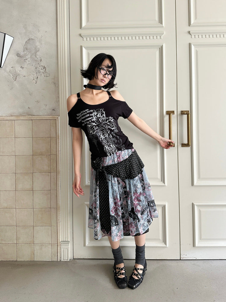 4RE1GN CROSS RIBBON jacquard lace layered skirt in multicolor — full-length modeled view with one arm extended