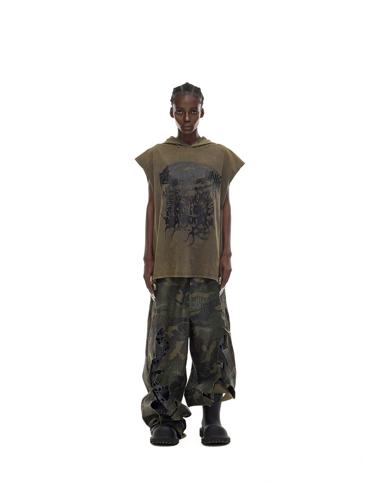PINKSPINK DOUBLE STACK distressed camouflage wide-leg jeans — straight-on full-length modeled view with an olive sleeveless top