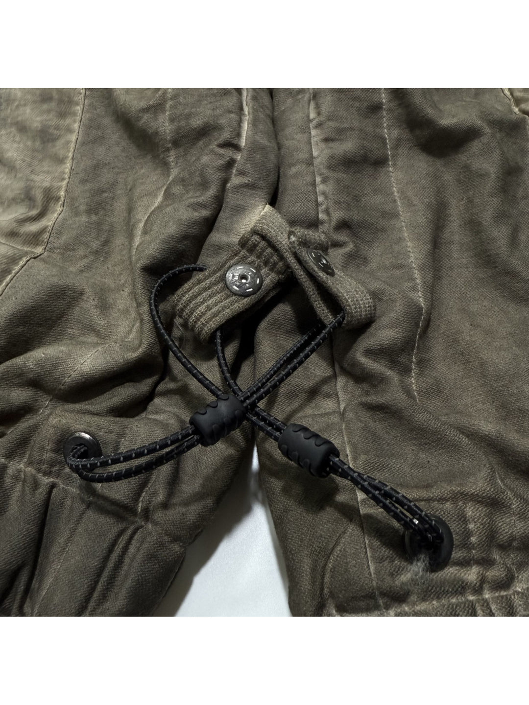 PIONEER cargo pants cuff snap fasteners and drawcord toggle close-up