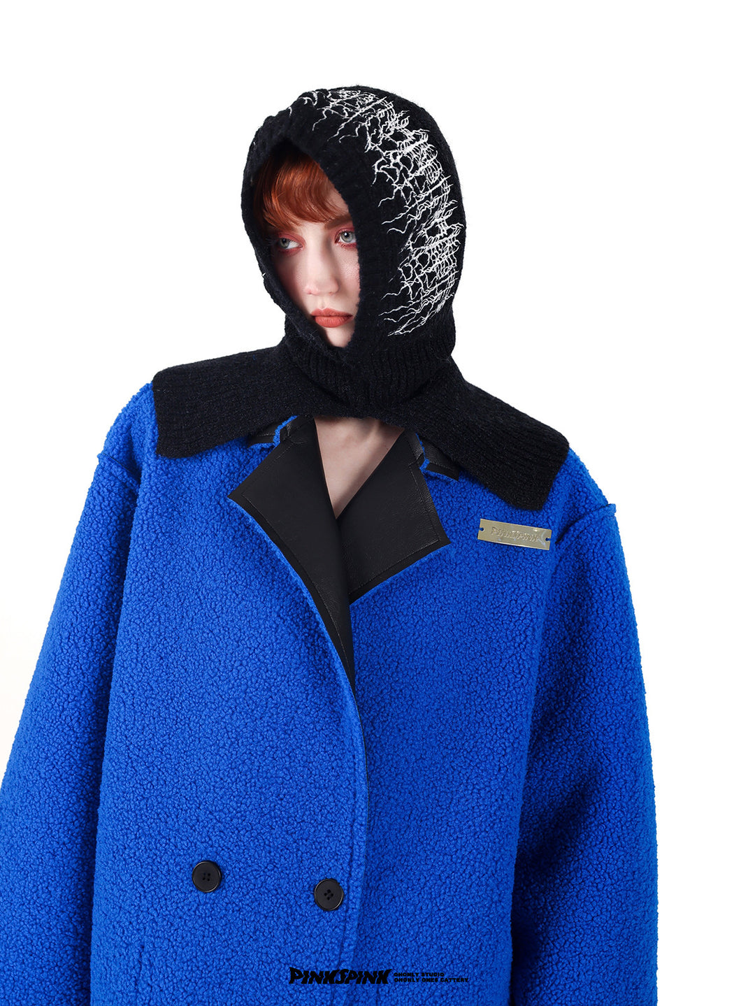 PINKSPINK ELECTRIC THORN embroidered knit balaclava in black — front modeled close-up with a blue textured coat