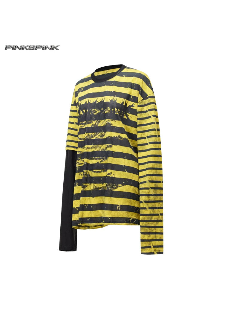 PINKSPINK STATIC asymmetric striped burnout long-sleeve tee — black-and-yellow striped asymmetric long-sleeve tee, angled product view