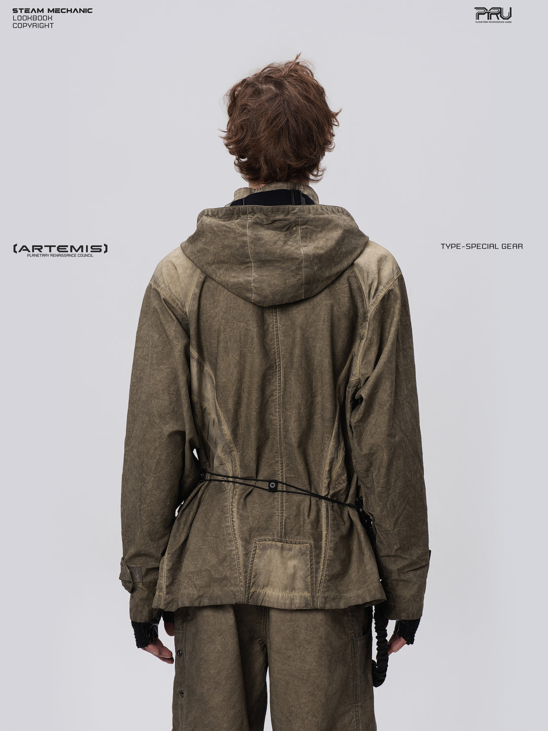 STARCORE distressed work jacket in lunar soil green — back modeled close-up showing hood and geometric rear panels