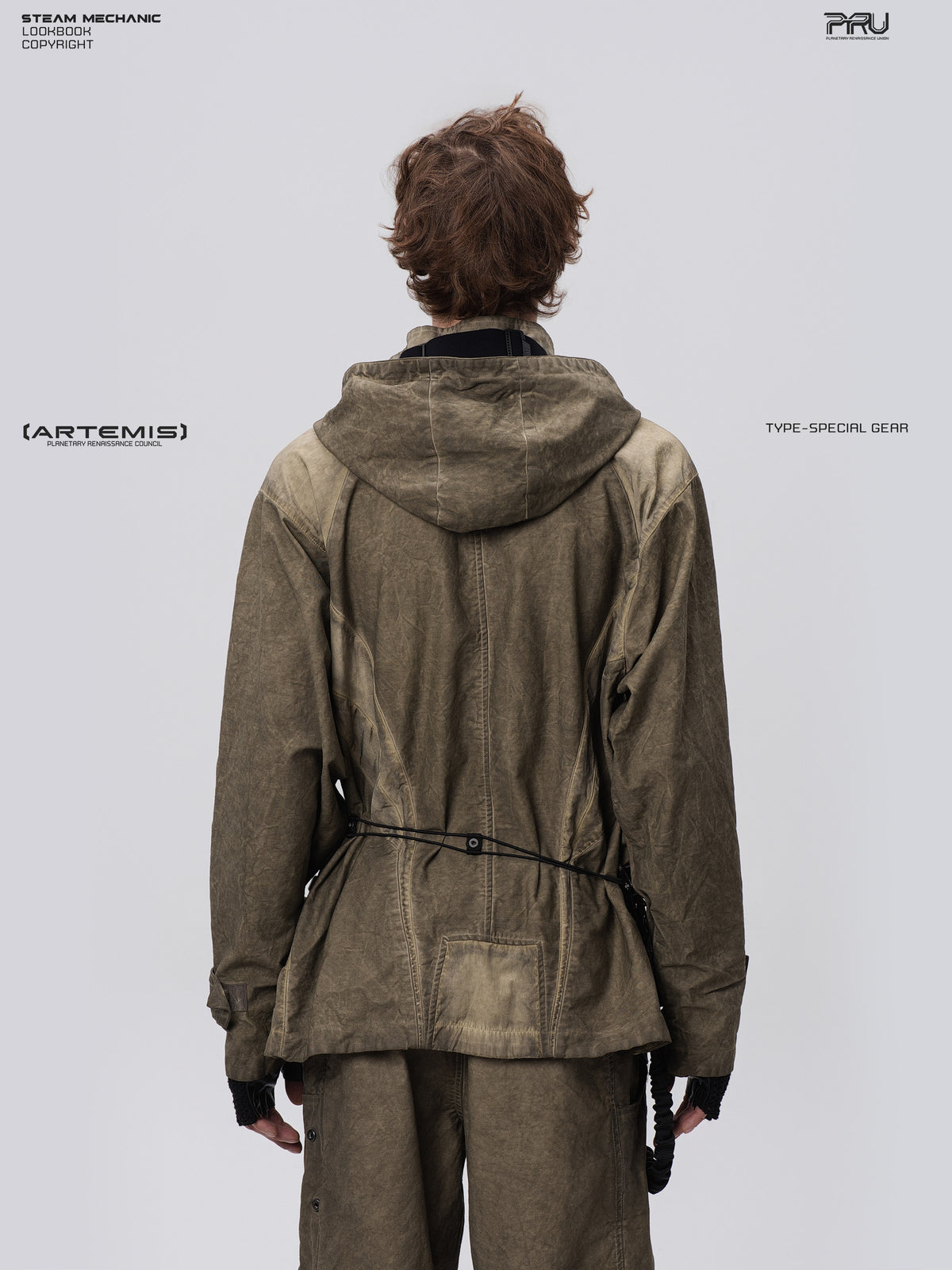 STARCORE distressed work jacket in lunar soil green — back modeled close-up showing hood and geometric rear panels