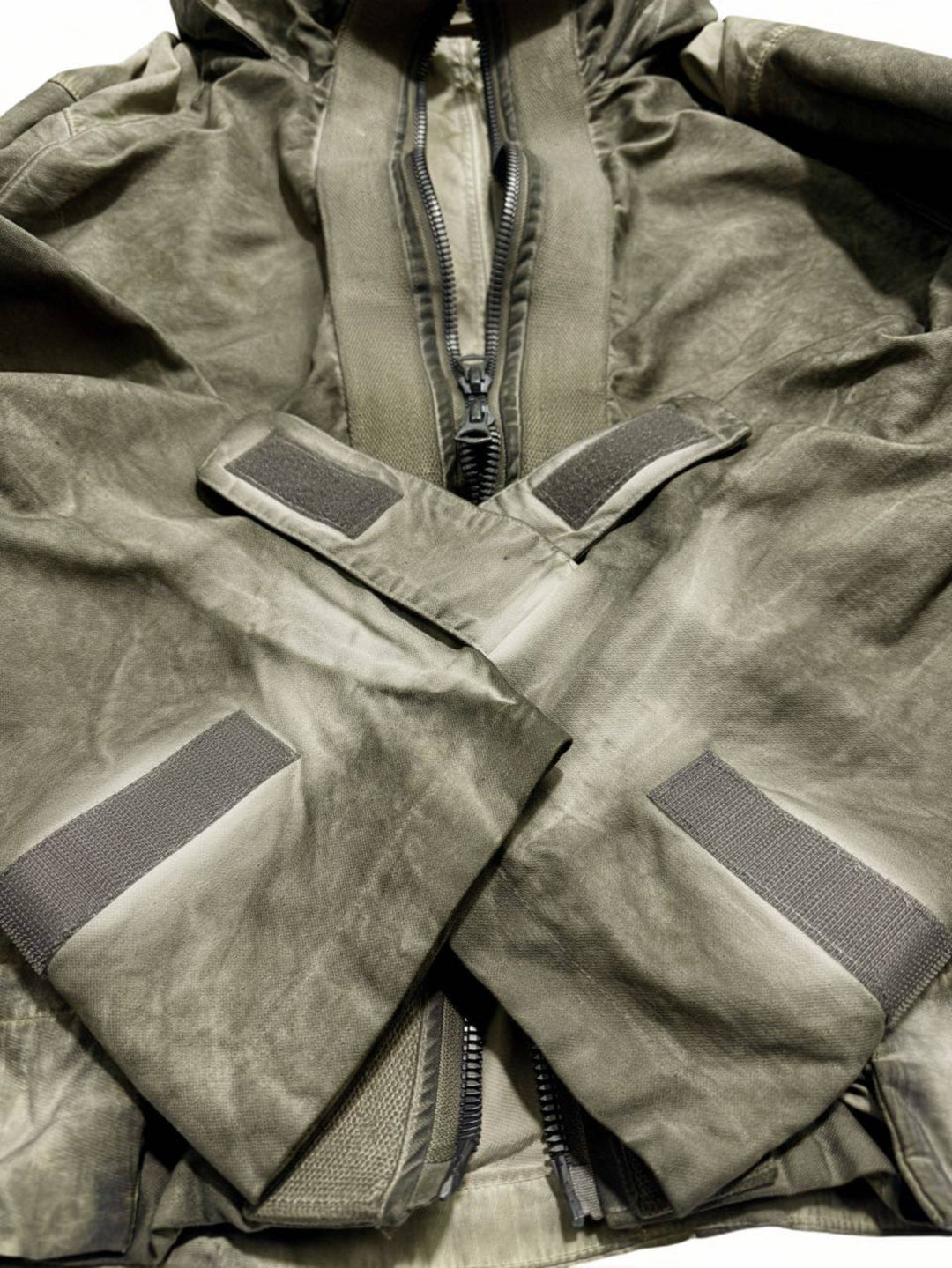 STARCORE distressed work jacket in lunar soil green — close-up of adjustable hook-and-loop cuffs and two-way zipper