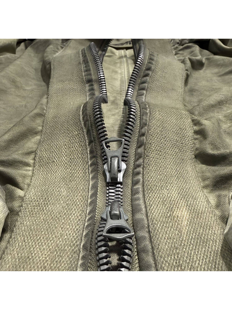 STARCORE distressed work jacket in lunar soil green — close-up of the two-way zipper and woven placket