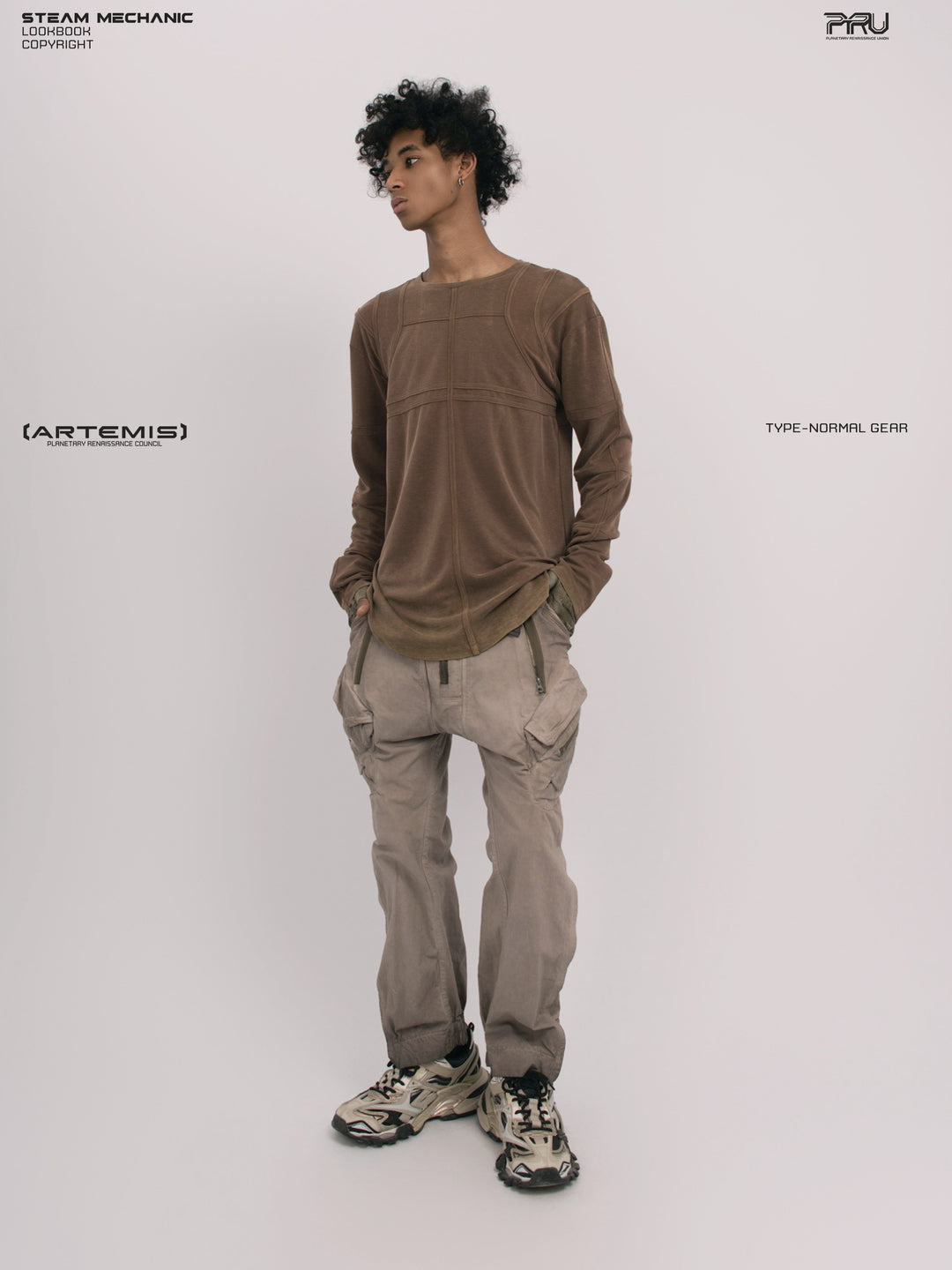 RUSTED ORBIT petrified brown mesh-panel long-sleeve top — full-length front modeled view with hands in pockets