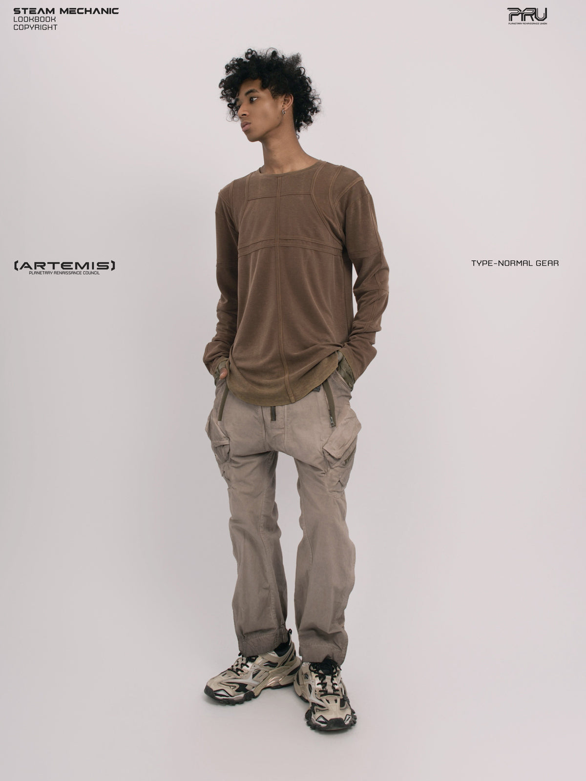 RUSTED ORBIT petrified brown mesh-panel long-sleeve top — full-length front modeled view with hands in pockets