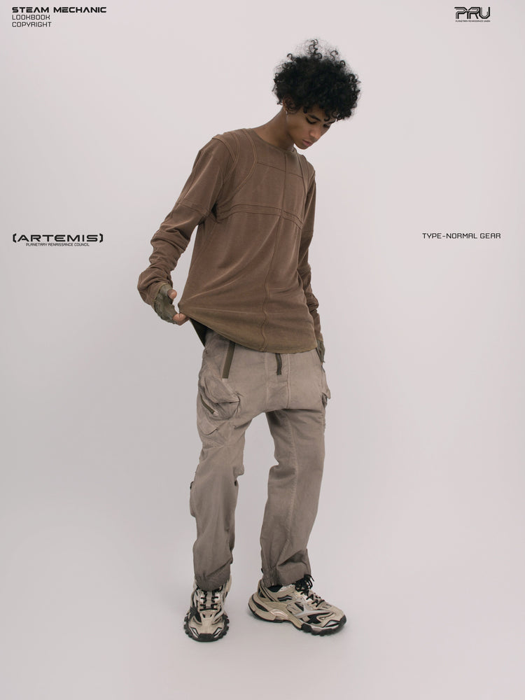 RUSTED ORBIT petrified brown mesh-panel long-sleeve top — full-length front modeled view showing the hem extended