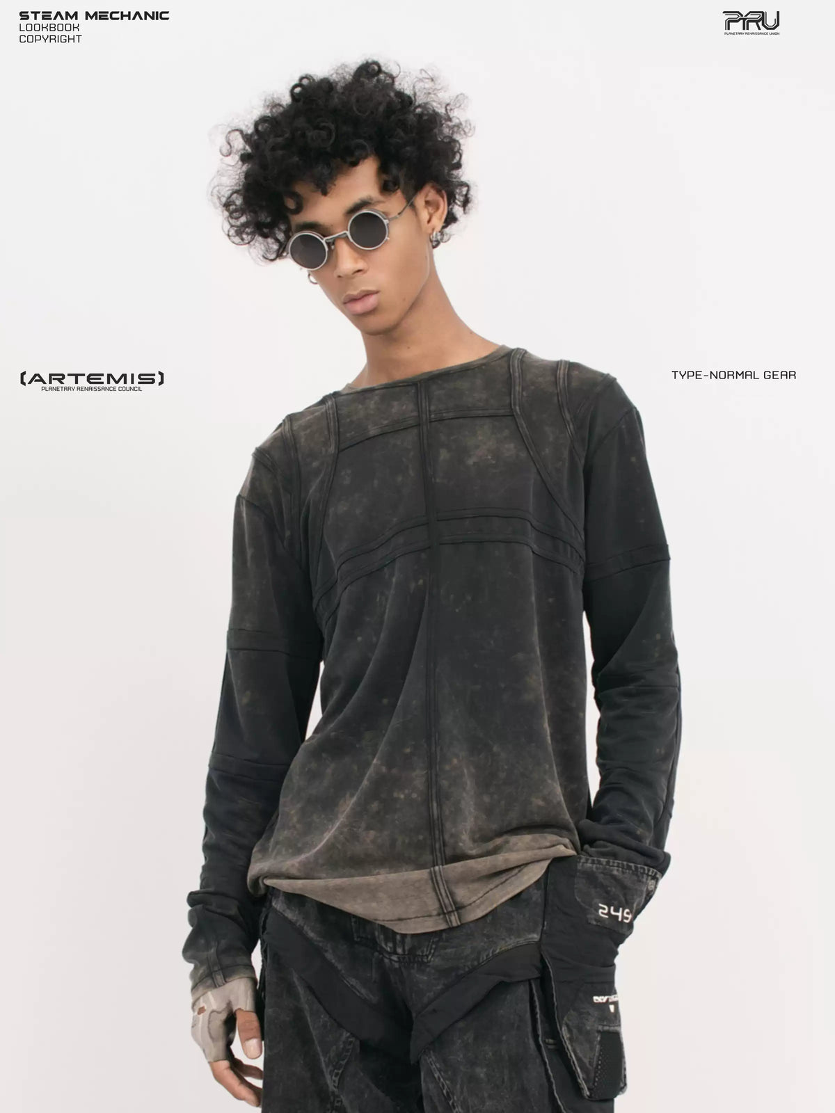 RUSTED ORBIT mesh-panel long-sleeve top in phantom black — front modeled close-up showing curved panel seams and the washed hem