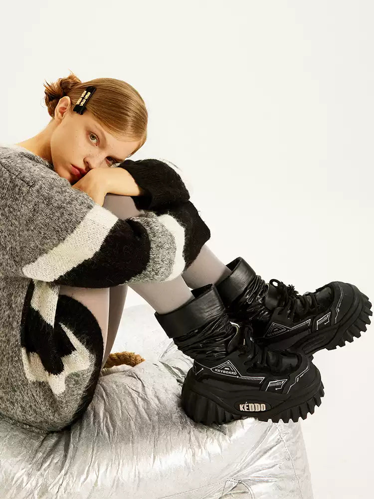 KEDDO KEYBOARD chunky winter boots in BLACK — seated modeled view with both boots on the silver chair.