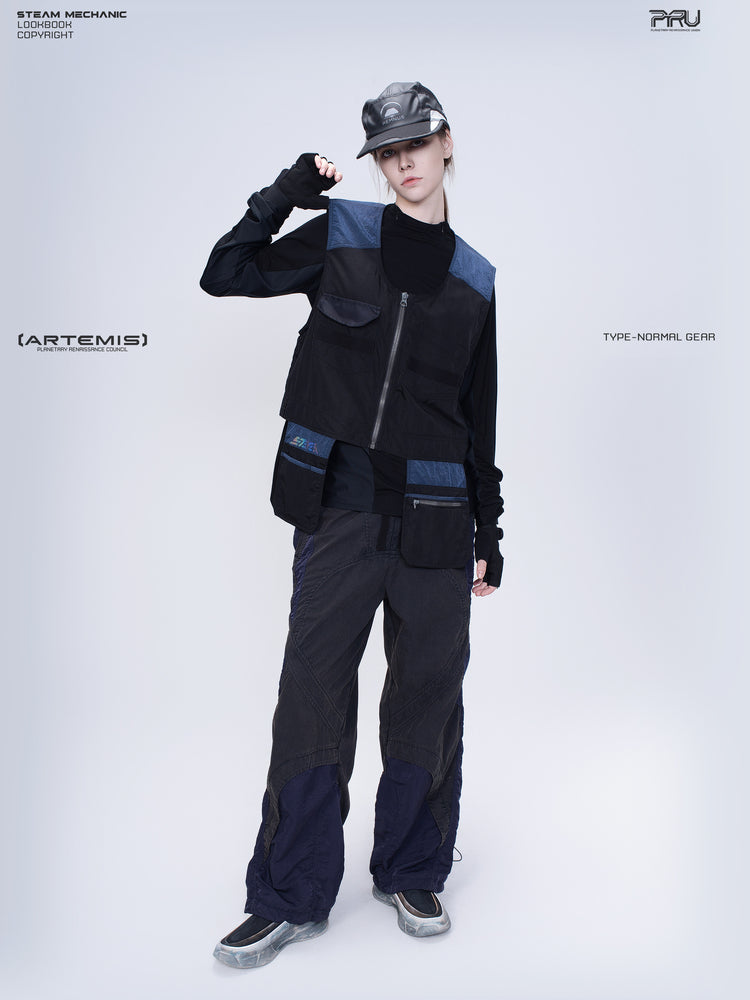 PIONEER stardust black multi-pocket technical vest — full-length modeled front view with hand beside the face