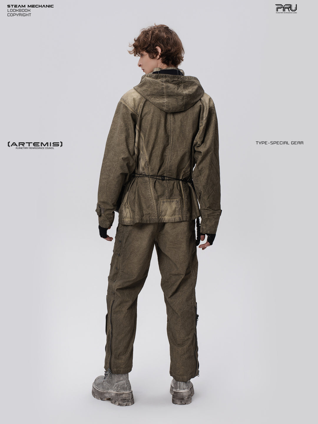 PIONEER knee-mesh utility work pants in lunar soil green — three-quarter rear full-length modeled view showing the side leg fasteners