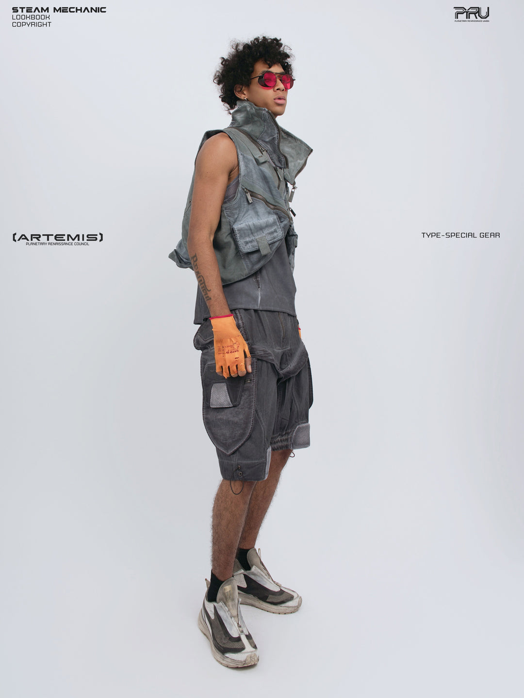 ARTEMIS stellar blue detachable technical shorts — side-front full-outfit view styled with a cropped utility vest