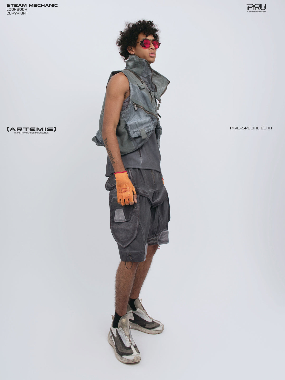 ARTEMIS stellar blue detachable technical shorts — side-front full-outfit view styled with a cropped utility vest