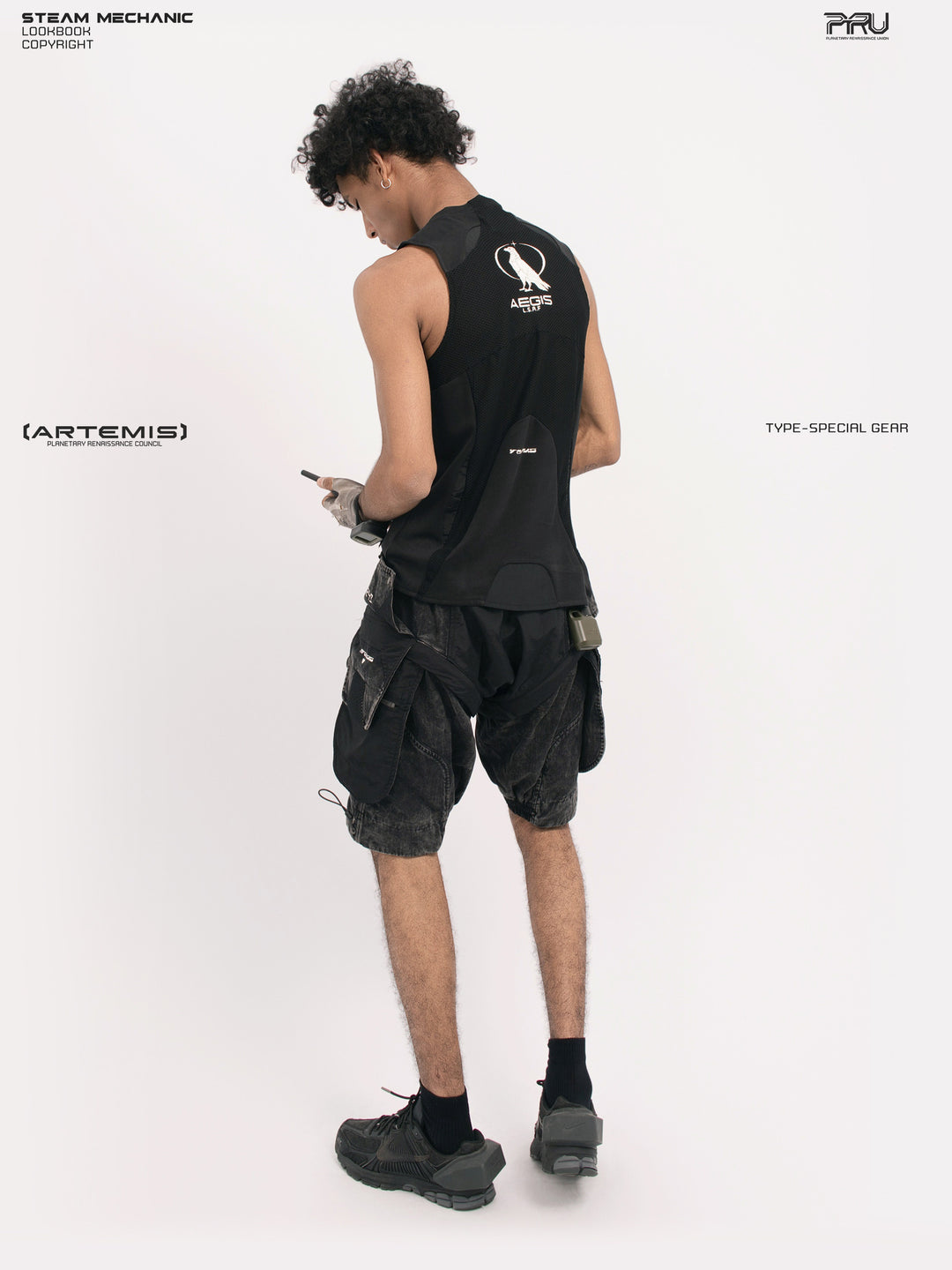 ARTEMIS blackbird black detachable technical shorts — rear three-quarter full-outfit view showing the side cargo pocket