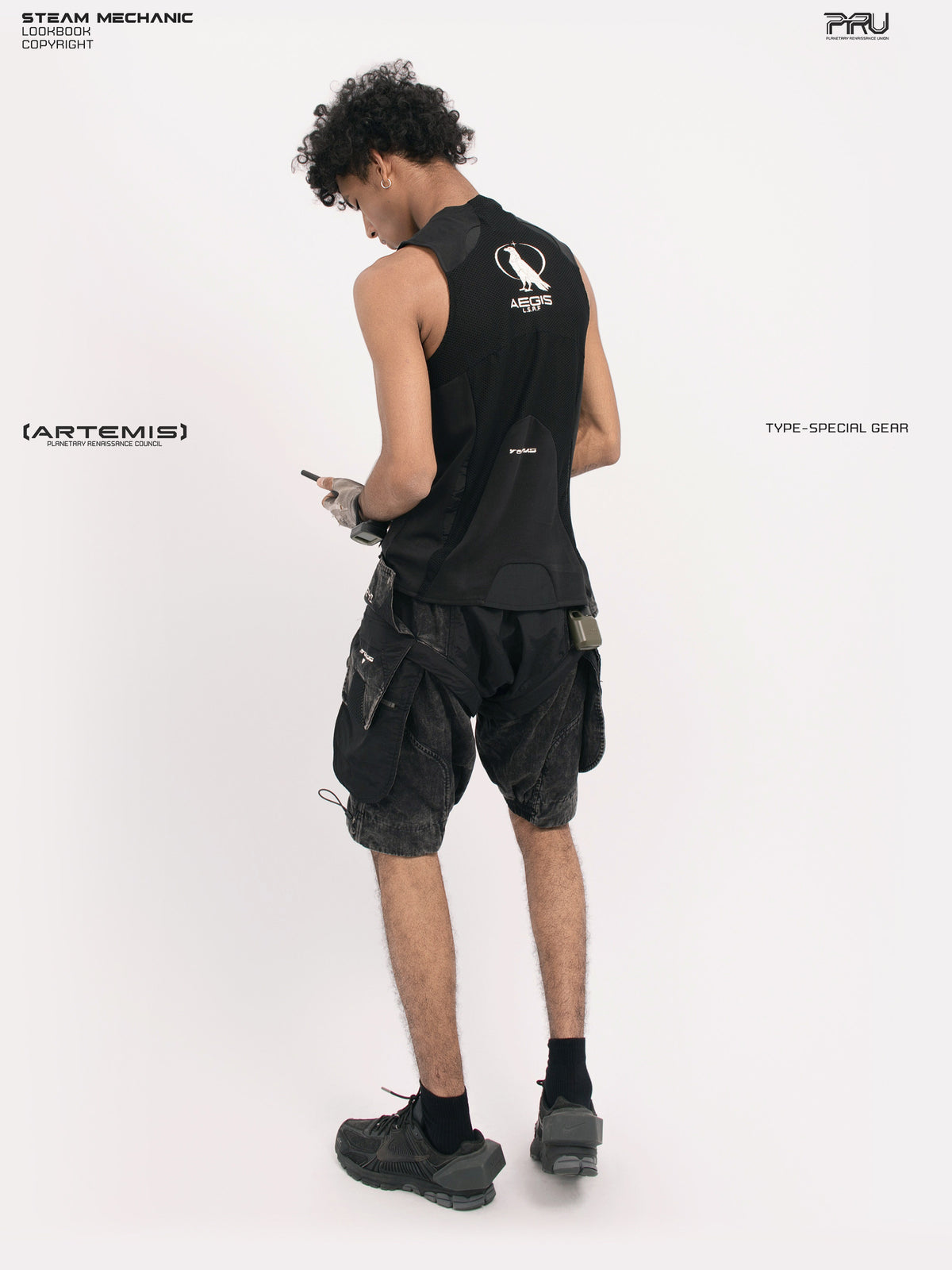 ARTEMIS blackbird black detachable technical shorts — rear three-quarter full-outfit view showing the side cargo pocket