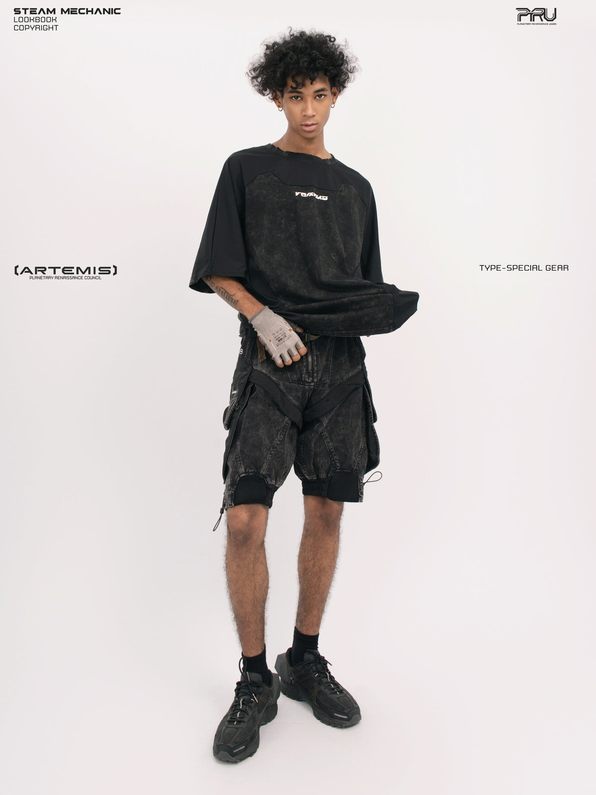 ARTEMIS blackbird black detachable technical shorts — front full-outfit view with the tee lifted to show the waist