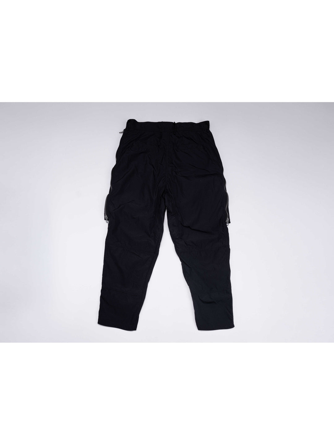GAIA curved-blade technical pants in night black — back garment-only view showing the straight seat seams