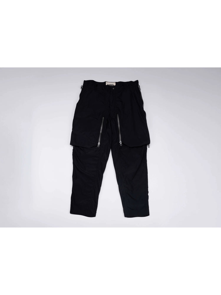GAIA curved-blade technical pants in night black — front garment-only view with curved zip panels closed