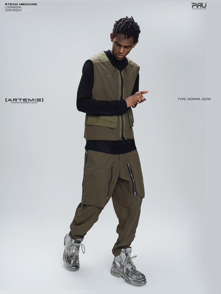 GAIA curved-blade technical pants in stone green — full-length modeled front view with matching vest styling
