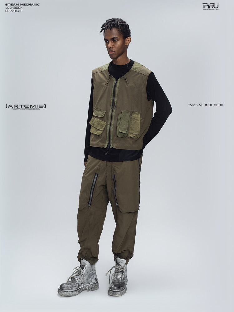 GAIA curved-blade technical pants in stone green — full-length modeled three-quarter view with matching vest styling
