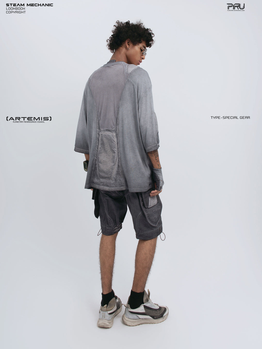 STARCORE stellar blue distressed mesh tee — full-length modeled rear three-quarter view showing the long mesh panel