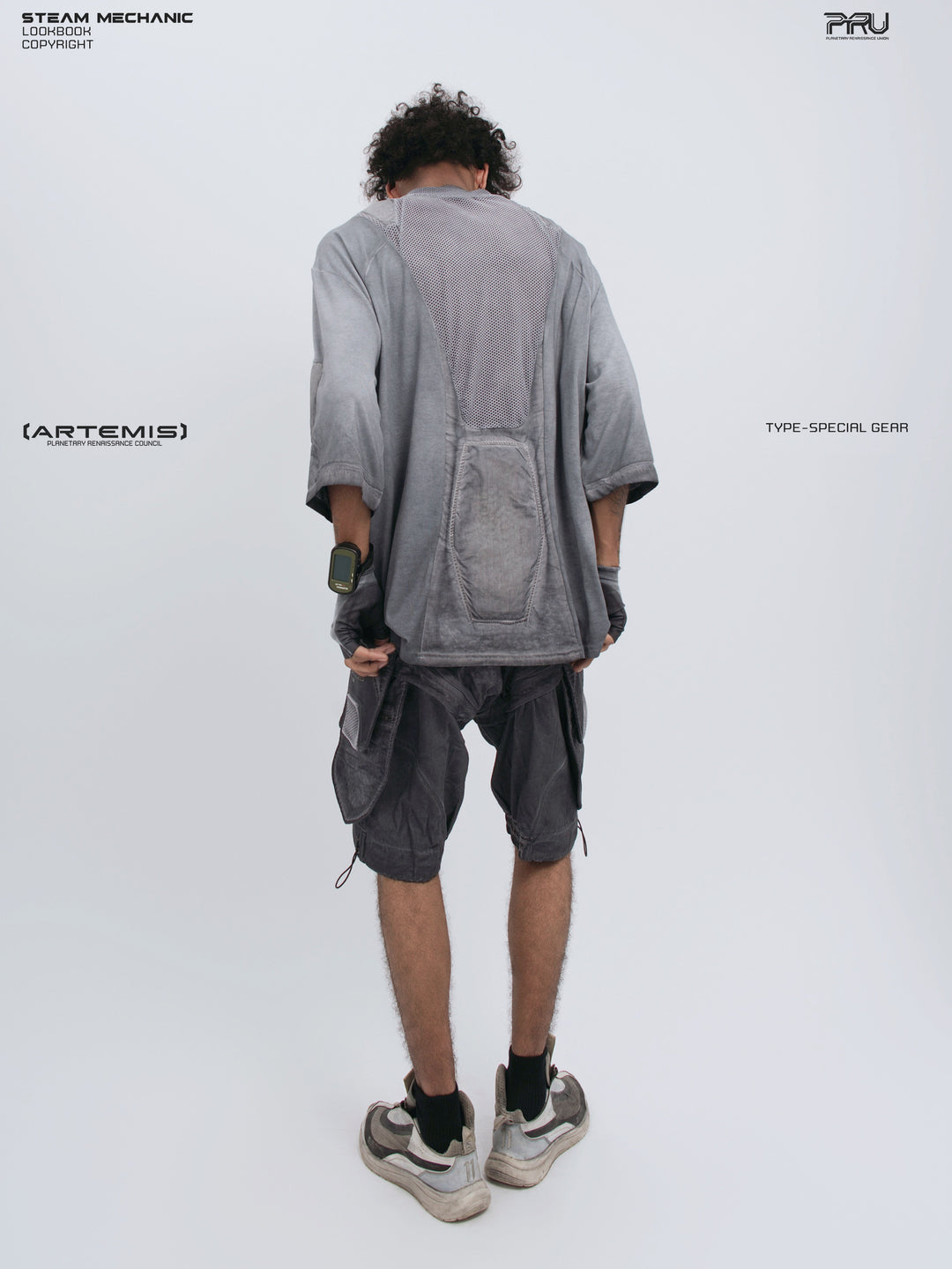 STARCORE stellar blue distressed mesh tee — full-length modeled back view holding the hem