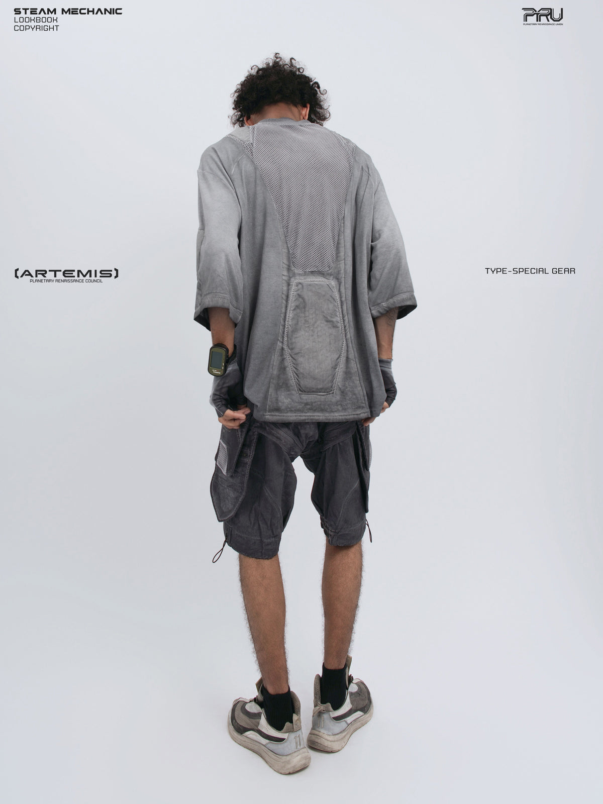 STARCORE moon dust gray distressed mesh tee — full-length modeled back view holding the hem