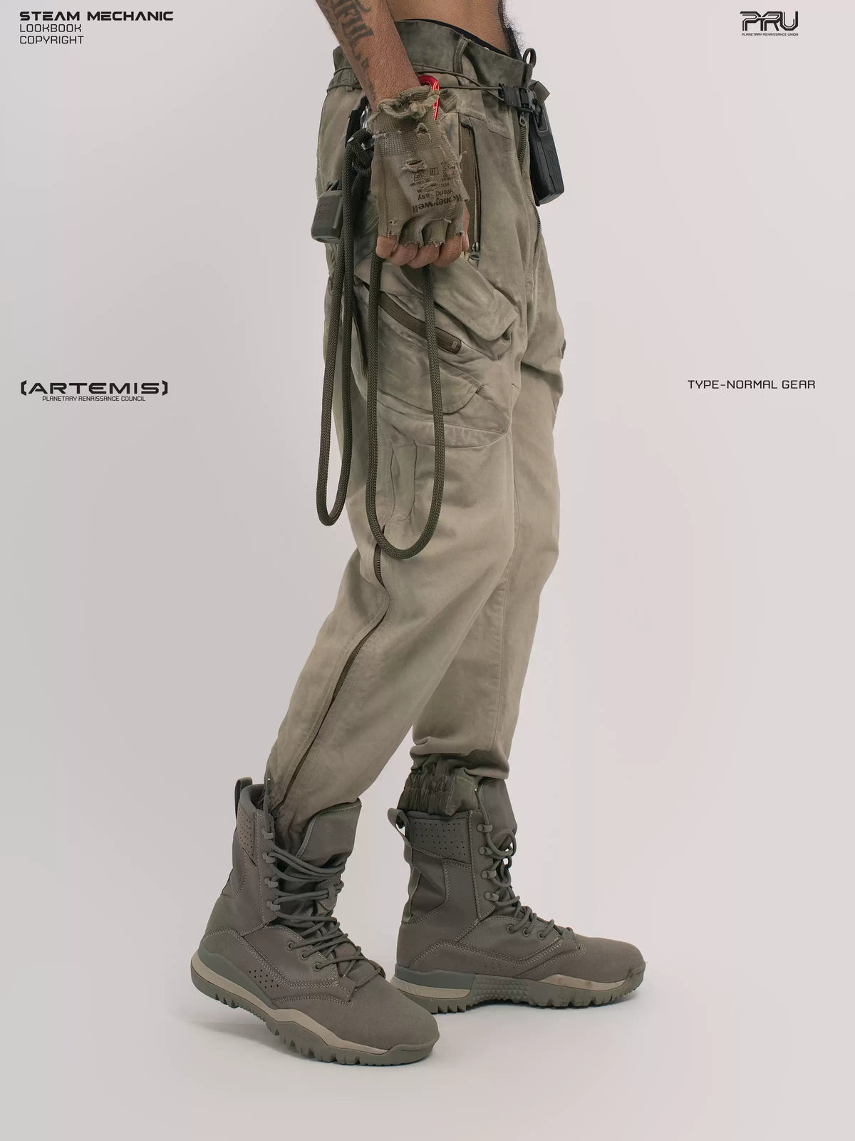 AEGIS lunar soil teal multi-pocket moto pants — side three-quarter modeled view with an open gloved hand