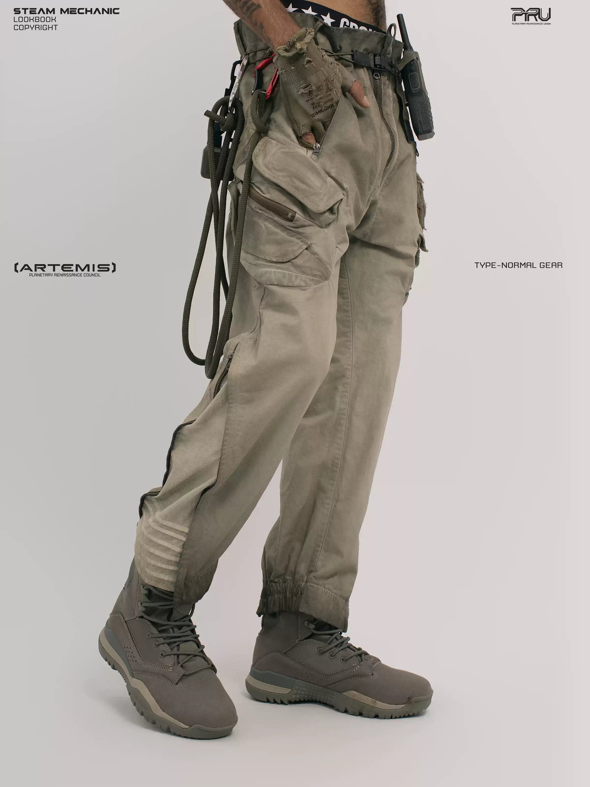 AEGIS lunar soil teal multi-pocket moto pants — front three-quarter modeled view with a hand in the cargo pocket