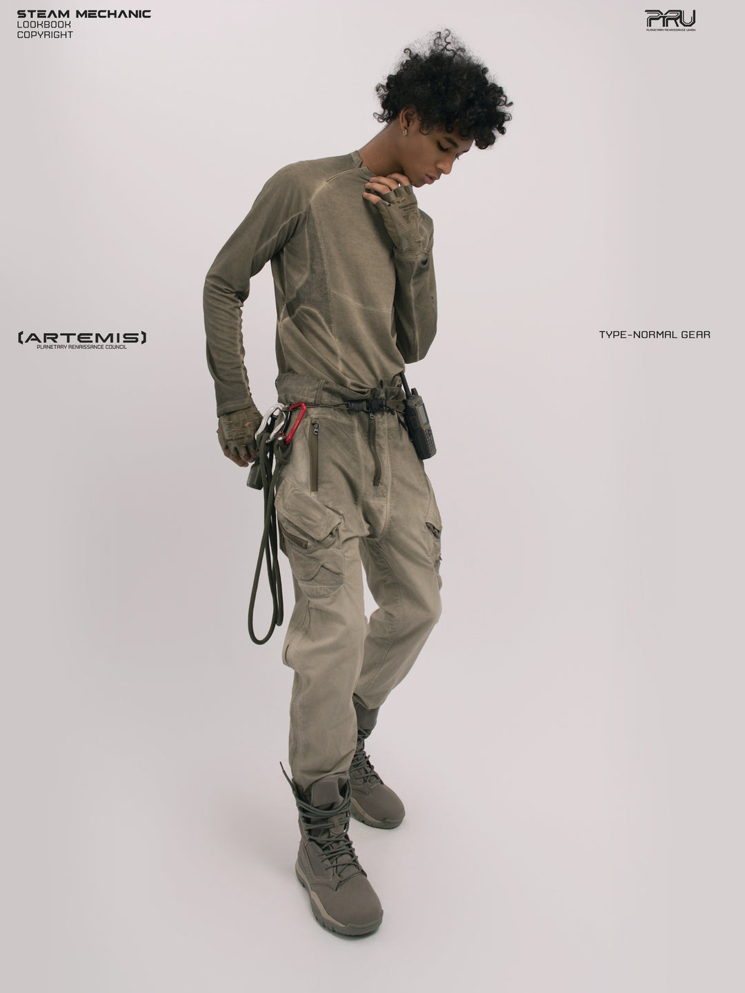 AEGIS lunar soil teal multi-pocket moto pants — full-length three-quarter front modeled view with one hand at the collar