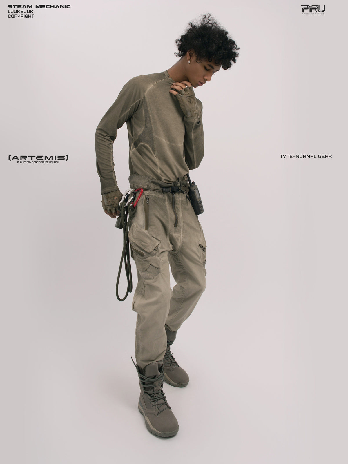 AEGIS lunar soil teal multi-pocket moto pants — full-length three-quarter front modeled view with one hand at the collar