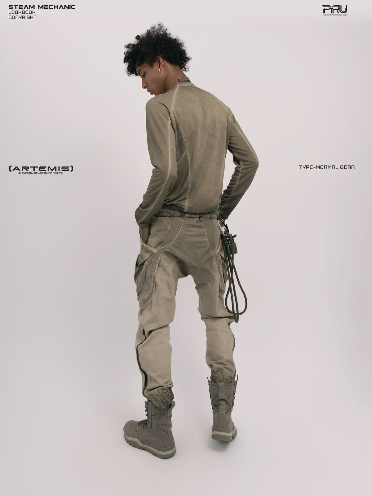 AEGIS lunar soil teal multi-pocket moto pants — full-length rear three-quarter modeled view showing the waist and seat
