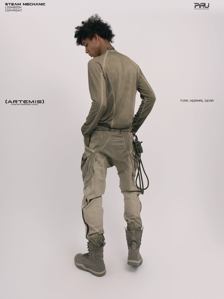 AEGIS lunar soil teal multi-pocket moto pants — full-length rear three-quarter modeled view showing the waist and seat