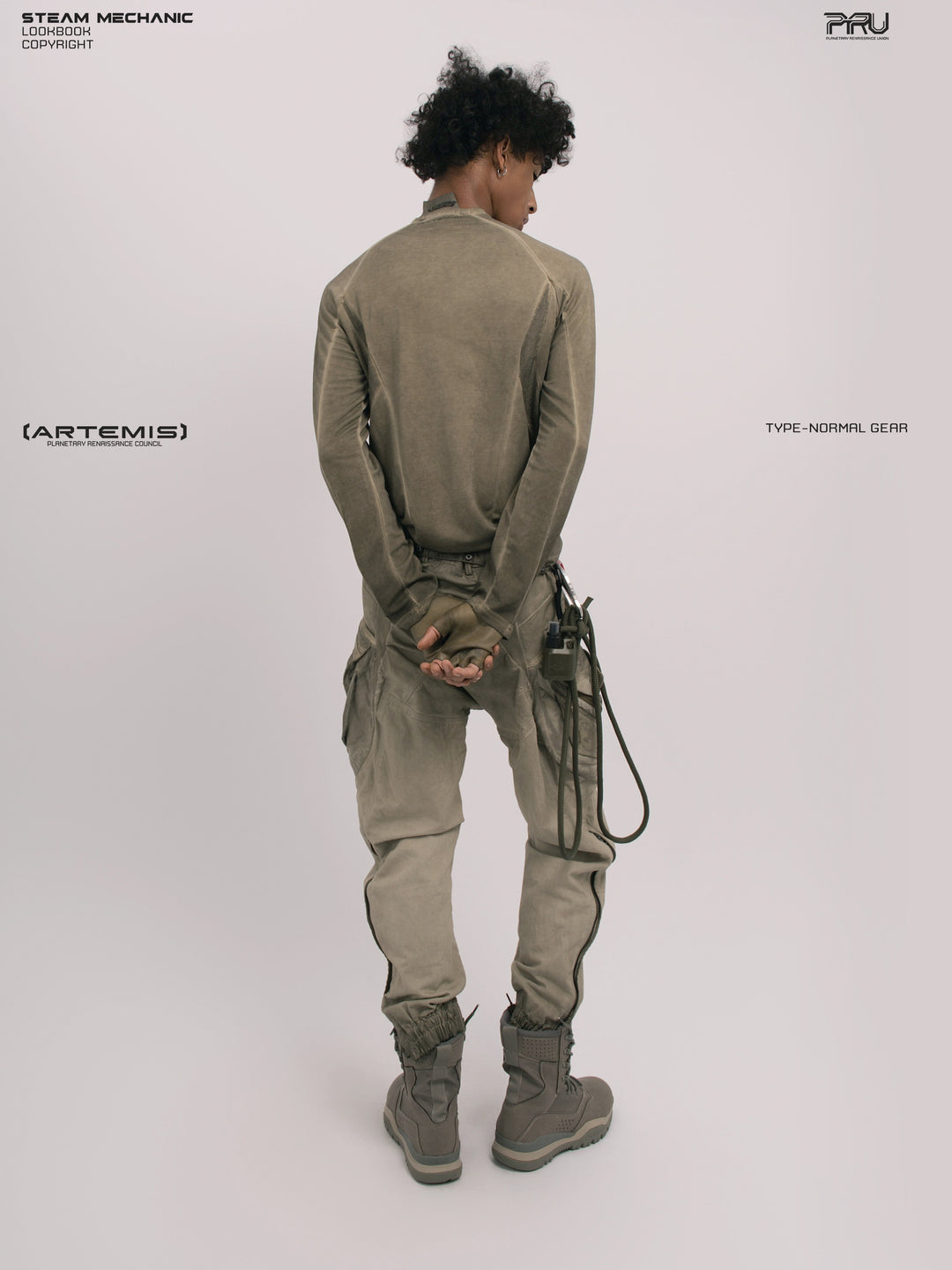 AEGIS lunar soil teal multi-pocket moto pants — full-length back modeled view showing the leg silhouette and calf zippers