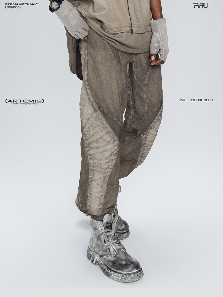 AEGIS cropped moto riding pants in mercury brown — three-quarter modeled close-up showing the side panels