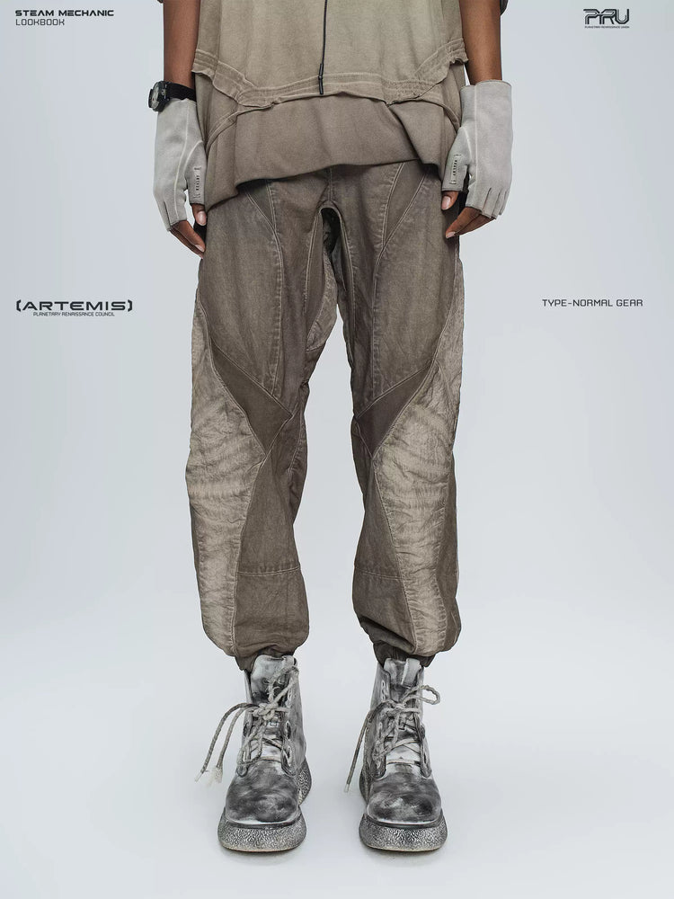 AEGIS cropped moto riding pants in mercury brown — front modeled close-up showing the angled panels and cropped elasticated cuffs