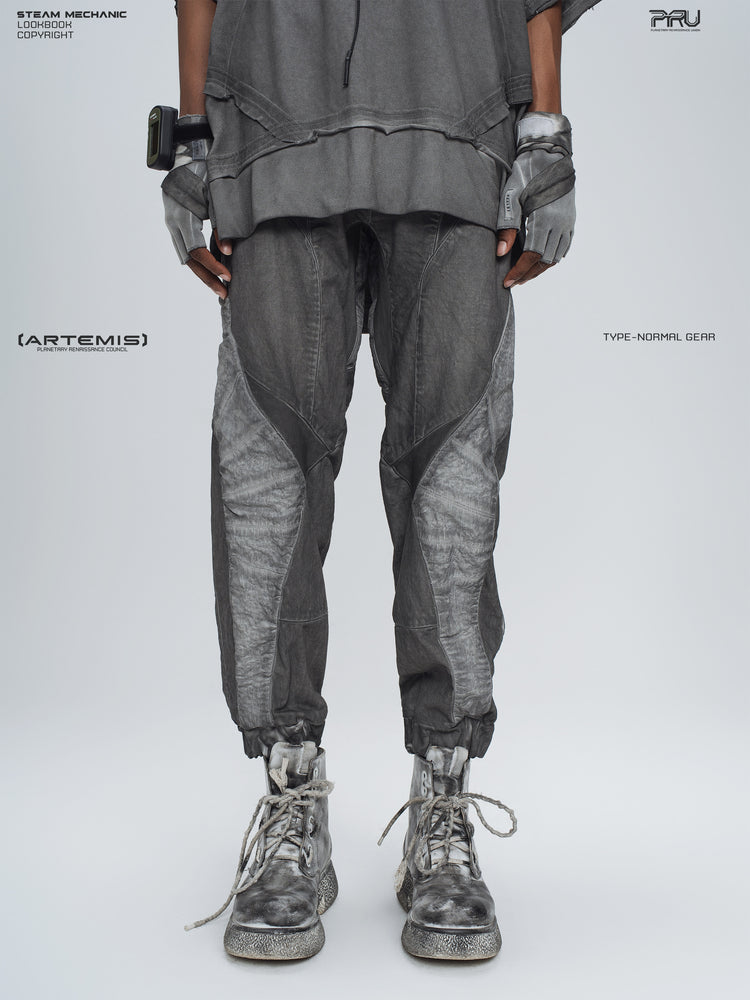 AEGIS moon dust gray cropped moto riding pants — front modeled view showing angled knee panels and gathered cuffs