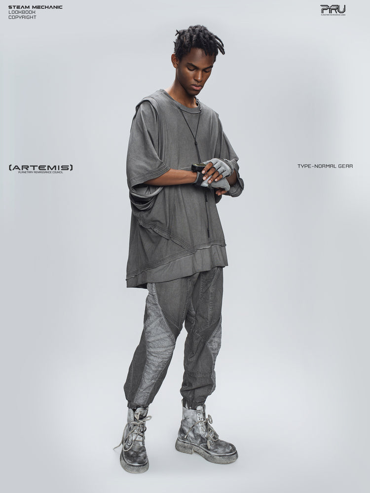 AEGIS moon dust gray cropped moto riding pants — full-body three-quarter modeled view with hands crossed