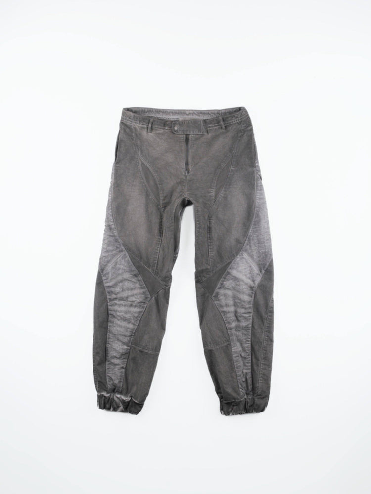 AEGIS moon dust gray cropped moto riding pants — front flat-lay showing angular washed gray panels and gathered cuffs