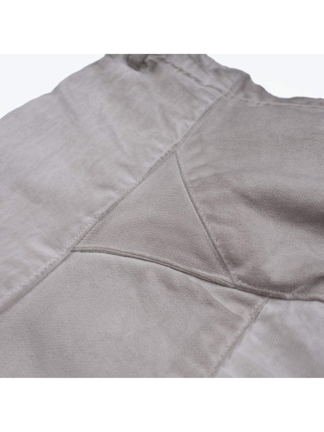 AEGIS eris white cropped moto riding pants — close-up of contrasting fabric panels and stitching