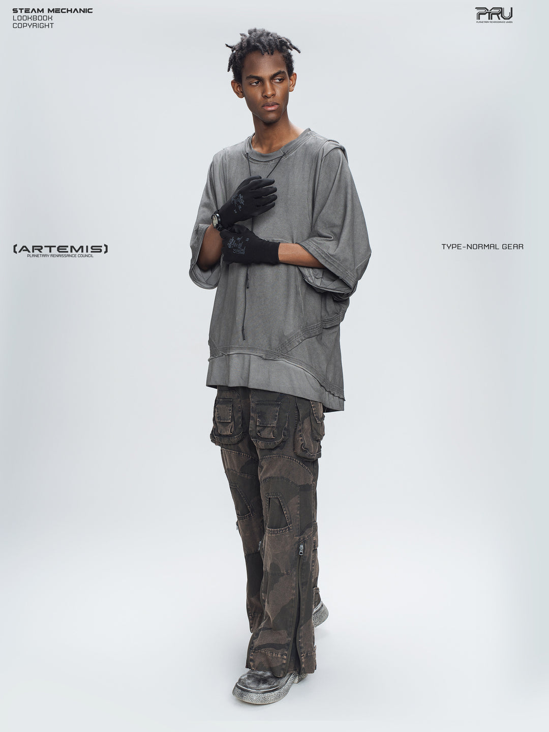 IXION dead leaf brown washed camouflage combat pants — full-length angled modeled view with hands raised