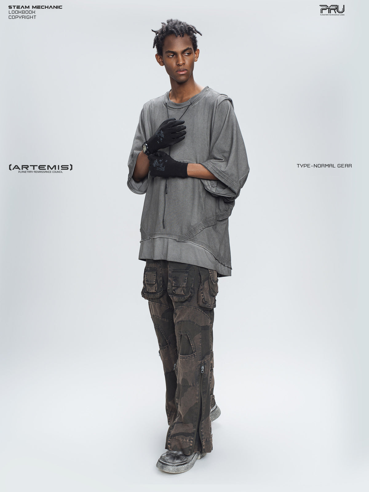 IXION dead leaf brown washed camouflage combat pants — full-length angled modeled view with hands raised