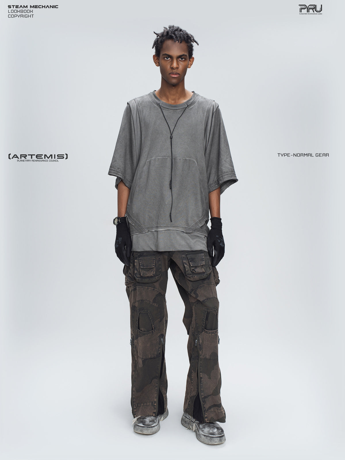 IXION dead leaf brown washed camouflage combat pants — full-length front modeled view styled with a gray tee